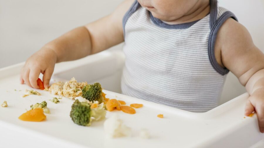 Imagem cute-baby-boy-highchair-choosing-what-eat
