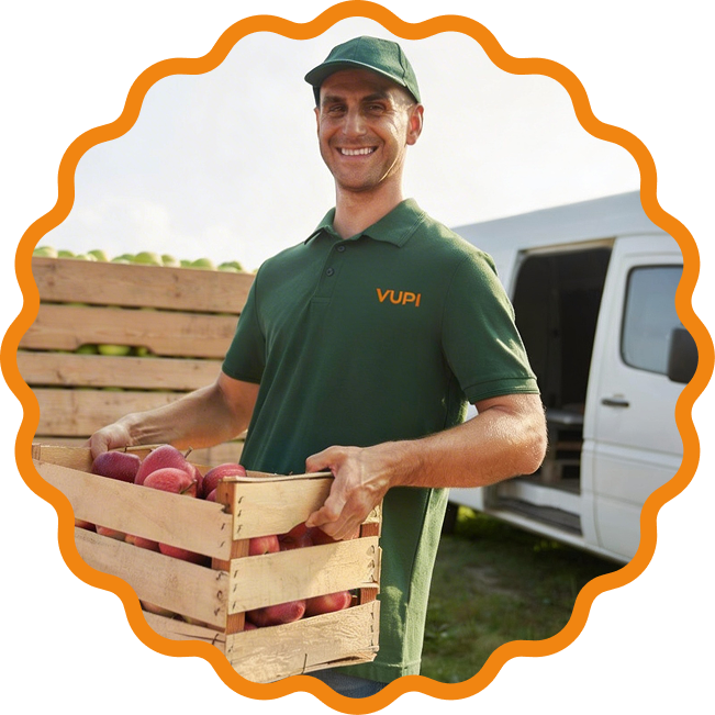 Entregador carregando caixas de frutas numa van